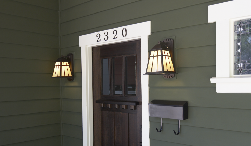 A front door with street numbers on top and lights on either side to illustrate how to use equity in your home