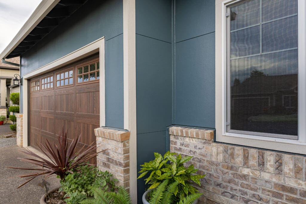 Close up of a new siding job with a garage door to illustrate what's HELOC